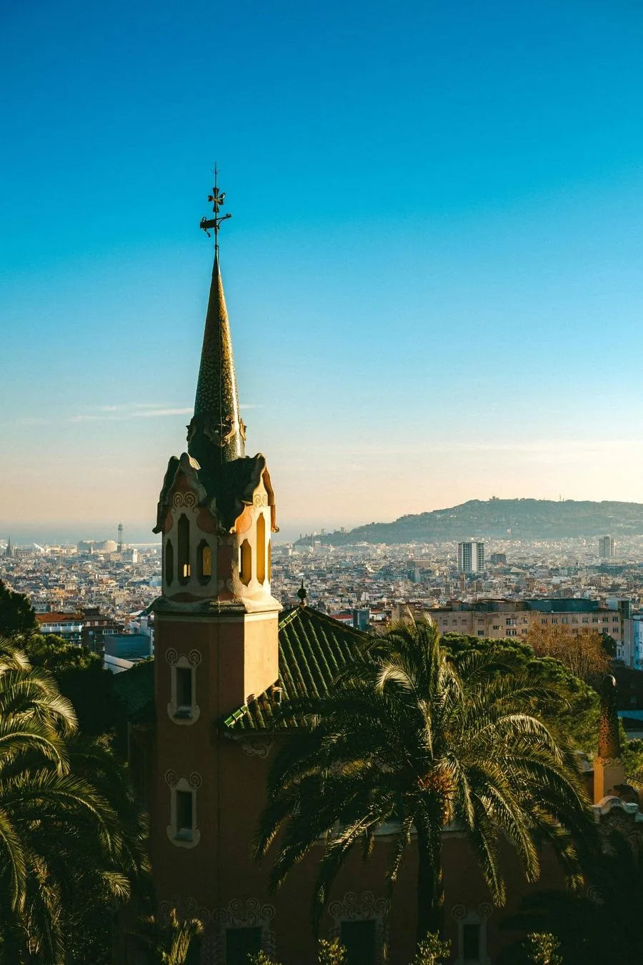 Gaudí tower at Park Güell rising above the Barcelona skyline